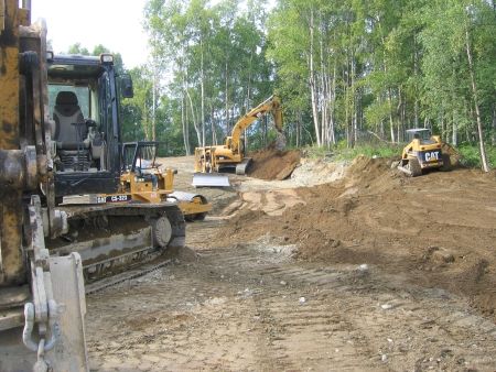Hailing dirt with an excavator and offload truck